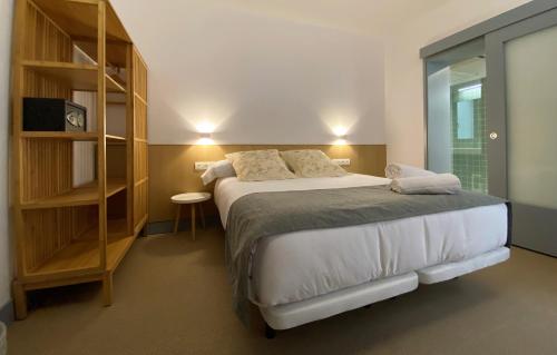 a bedroom with a bed and a book shelf at Barrio Rey in Toledo