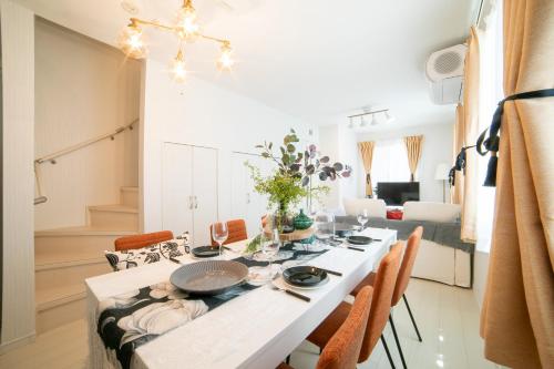 a dining room with a white table and chairs at Skytree view Oshiage in Tokyo