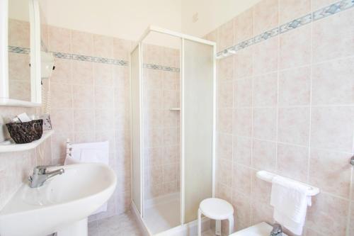 a bathroom with a shower and a sink and a toilet at Hotel Villa Giada in Marina di Massa