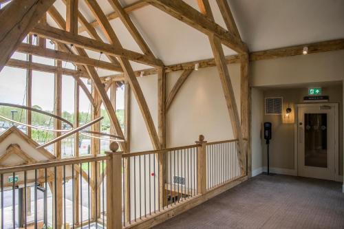 an empty room with wooden beams in a building at Sandburn Hall in York