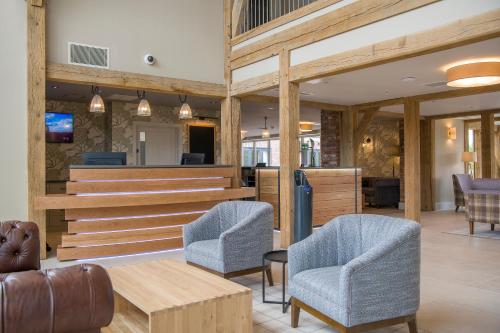 a lobby with two chairs and a table at Sandburn Hall in York
