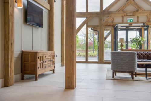 a living room with a tv and a table and chairs at Sandburn Hall in York