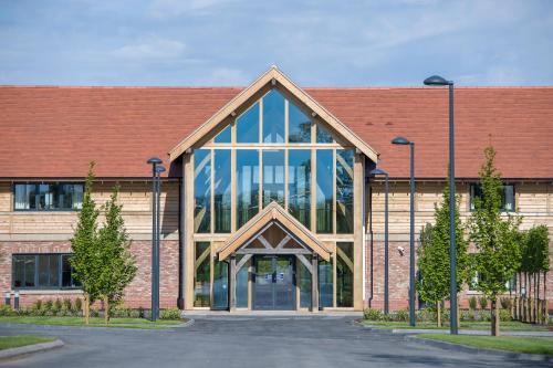a large brick building with a large window at Sandburn Hall in York