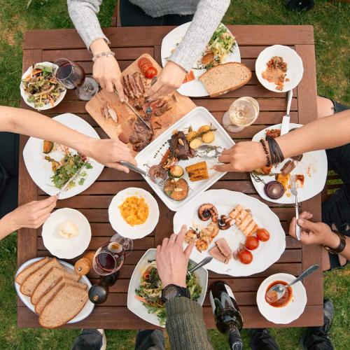 a group of people sitting around a table eating food at Ambrožův dvůr in Pouzdřany