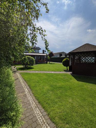 a yard with a gazebo and a house at MDS Wielichowo in Wielichowo