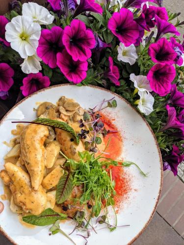 a plate of food on a table with flowers at MDS Wielichowo in Wielichowo