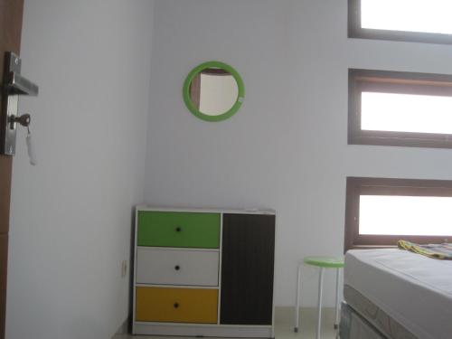 a bedroom with a dresser and a mirror on the wall at Cemara Homestay Jogja in Yogyakarta