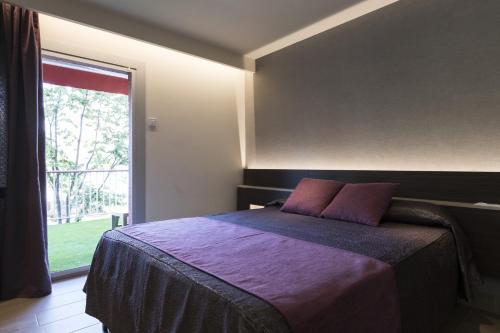 Un pat sau paturi într-o cameră la Hotel Papi Blau