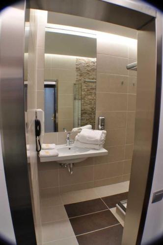 a bathroom with a sink and a mirror at X Dream Hotel-Adults Only in Athens