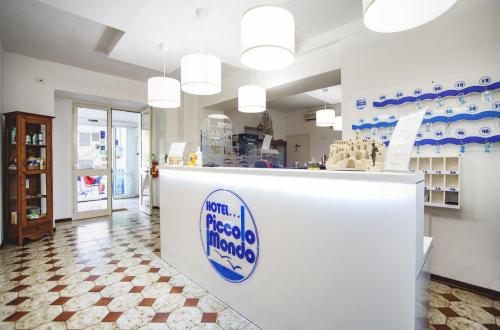 a store with a counter with a sign on it at Hotel Piccolo Mondo in Acquappesa