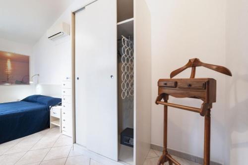 a bedroom with a bed and a mirror next to a room at Hotel Piccolo Mondo in Acquappesa