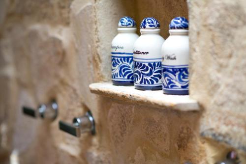 a group of blue and white bottles sitting on a wall at Nayara Springs - Adults Only in Fortuna