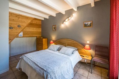 a bedroom with a bed and a bench in a room at Chambres d'hotes Les Clarines in Saint-Jacques-en-Valgodemard
