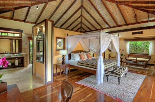 a bedroom with a bed with a canopy at Nayara Springs - Adults Only in Fortuna