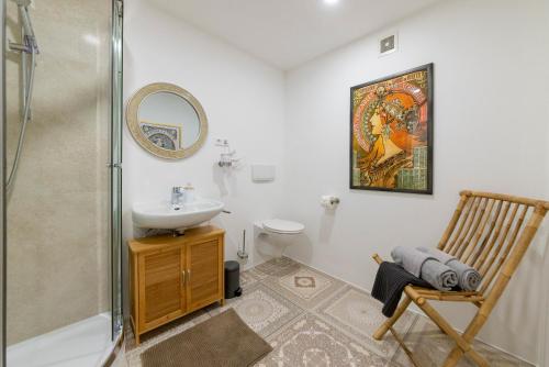 un bagno con lavandino, WC e specchio di Apartment 10 a Stockach