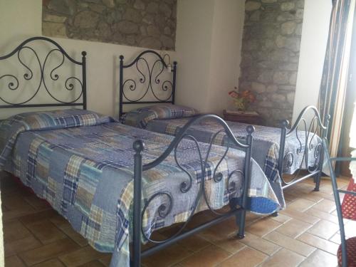 Ένα ή περισσότερα κρεβάτια σε δωμάτιο στο Borgo di Corte - alloggio agrituristico
