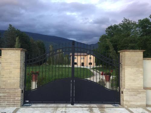 a black gate in front of a house at Il Castellaccio in Spello