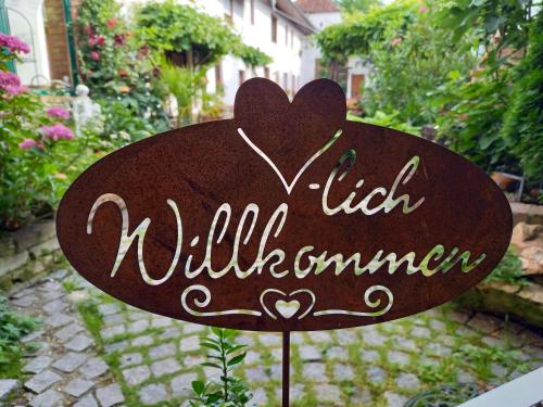 a sign that says hello will summonimer in a garden at Winzerhof Fleischmann in Kleinhöflein