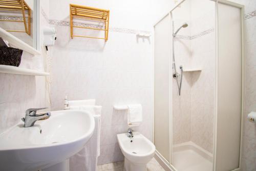 a bathroom with a sink and a toilet and a shower at Hotel Villa Giada in Marina di Massa