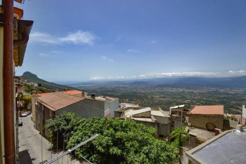 a view of a city with mountains in the distance at Appartamento vista incantevole Domm'e Orrosaria in Baunei