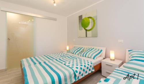 a bedroom with two beds and two candles at Apartments Kolenc in Portorož