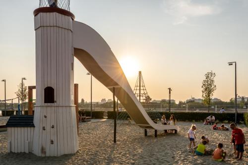 a group of children playing on a slide at Beograd na vodi - Belgrade Waterfront Riverside in Belgrade