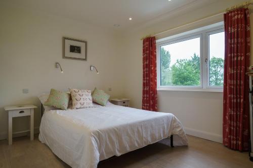 a bedroom with a bed and a large window at Lyth Valley View at Broom Bank in Brigsteer