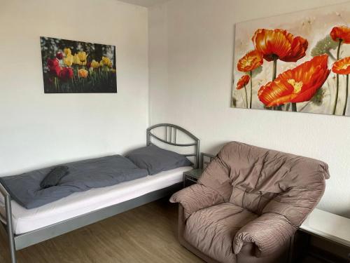 a room with a bed and a chair in it at Schönes einfaches Zimmer in Oldenburg in Oldenburg