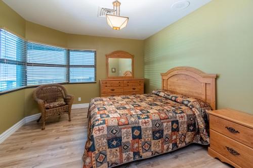 a bedroom with a bed and a dresser and a mirror at Condo avec parc aquatique ! in Beaupré