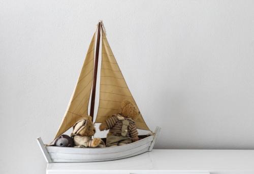 a toy sail boat with two teddy bears in it at Las Floridas Apartment in Alghero