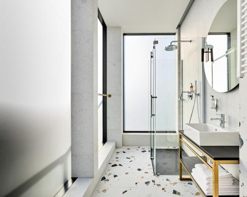 a bathroom with a sink and a shower at Hotel Liberte 33 BW Premier Collection in Poznań