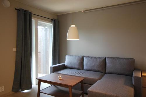 a living room with a couch and a table at Setnes Feriesenter in Veblungsnes