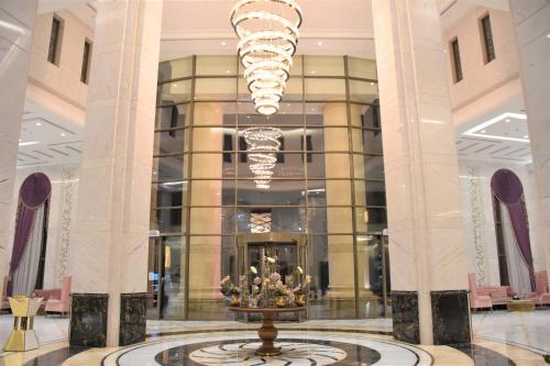a lobby with a fountain in the middle of a building at Midan Hotel & Suites Al Aziziya in Makkah