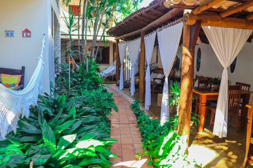 a patio of a house with a bunch of plants at Pousada Campestre in Trancoso