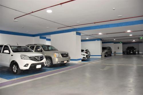a garage with several cars parked in it at Midan Hotel & Suites Al Aziziya in Mecca