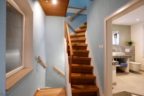 a staircase in a house with blue walls and wooden floors at Gemütliches Stadthaus im Herzen der Altstadt in Bad Dürkheim