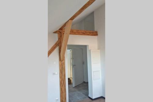 an attic room with wooden beams at Bad Aibling City Apartment DG in Bad Aibling