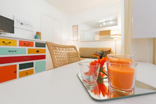 a tray with two glasses of orange juice on a table at Alfama Flats - Beco Dos Ramos in Lisbon