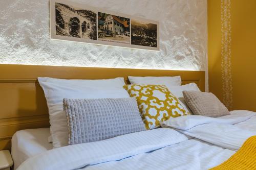 a bed with pillows on top of it at Frida's Old House in Bled