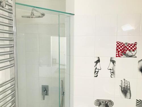 a bathroom with a shower with a glass door at La Palladiana - Immobilevante in Ponza