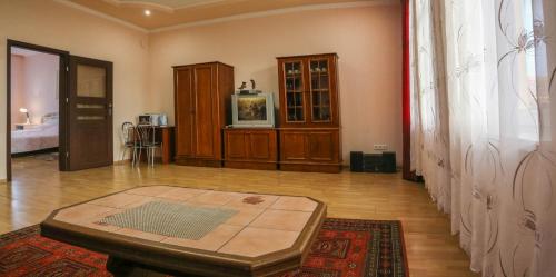 a living room with a table in the middle of a room at Отель центр Трускавца in Truskavets