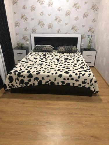 a bedroom with a black and white bed with two night stands at Akhaltsikhe hotel “Sunny House” in Akhaltsikhe