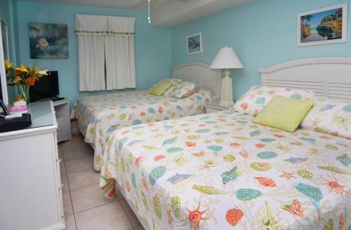 a bedroom with two beds and a tv in it at Laguna Keyes 707 in Myrtle Beach