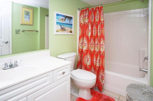 a bathroom with a toilet and a shower curtain at Laguna Keyes 707 in Myrtle Beach