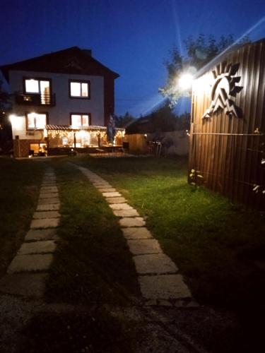 a house with a light on the side of a yard at Vysoké Tatry Gerlaška in Gerlachov