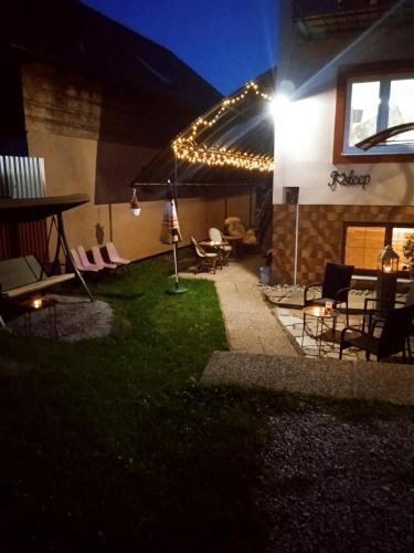a patio with a table and chairs and lights at Vysoké Tatry Gerlaška in Gerlachov