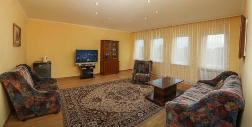 a living room with two couches and a television at Отель центр Трускавца in Truskavets