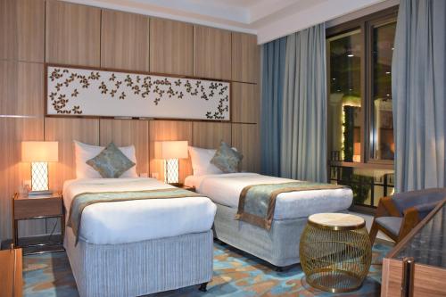 Postel nebo postele na pokoji v ubytování Midan Hotel & Suites Al Aziziya