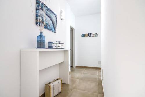 a hallway with white walls and a radiator at Domus B&B Le Nereidi in Lampedusa