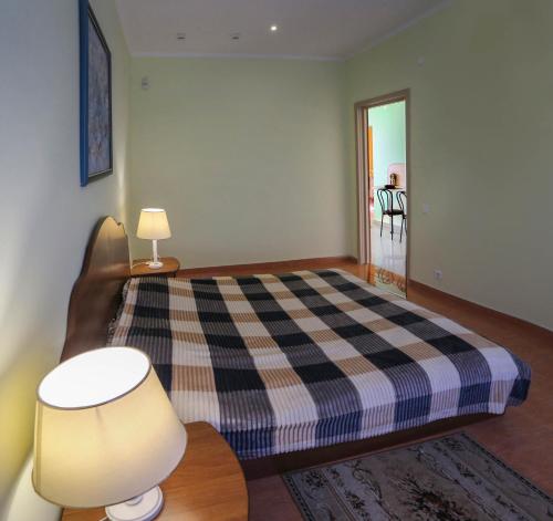 a bedroom with a bed and a table with a lamp at Отель центр Трускавца in Truskavets